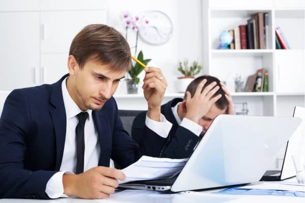 Men making mistakes in an office